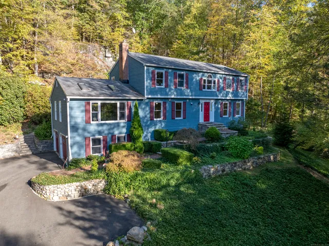 a view of a large brick building next to a yard