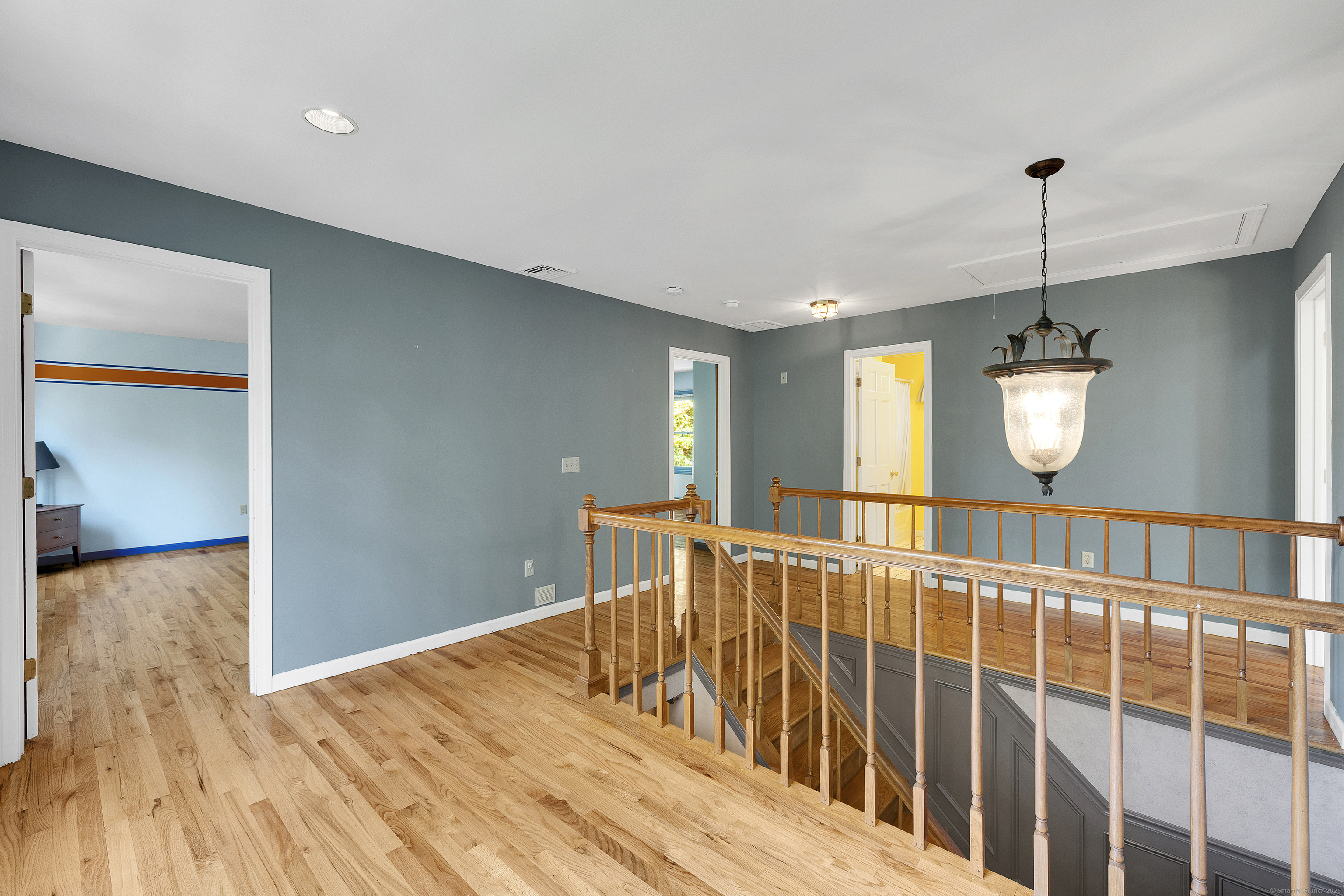 367 Sachem Road Southbury, CT 06488 - Photo 14 of 34 a view of a hallway with wooden floor and stairs