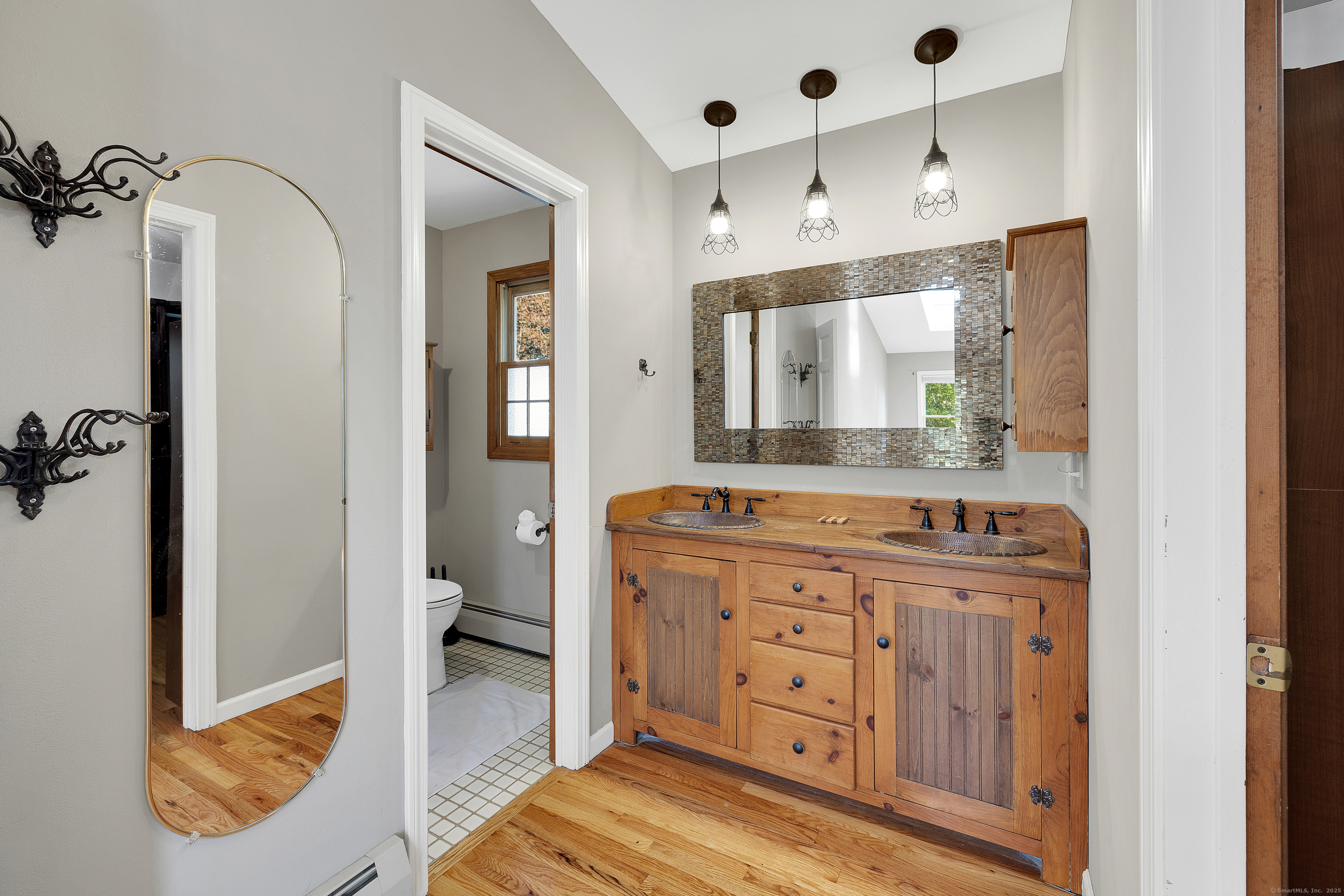 367 Sachem Road Southbury, CT 06488 - Photo 18 of 34 a bathroom with a double vanity sink and mirror with shower