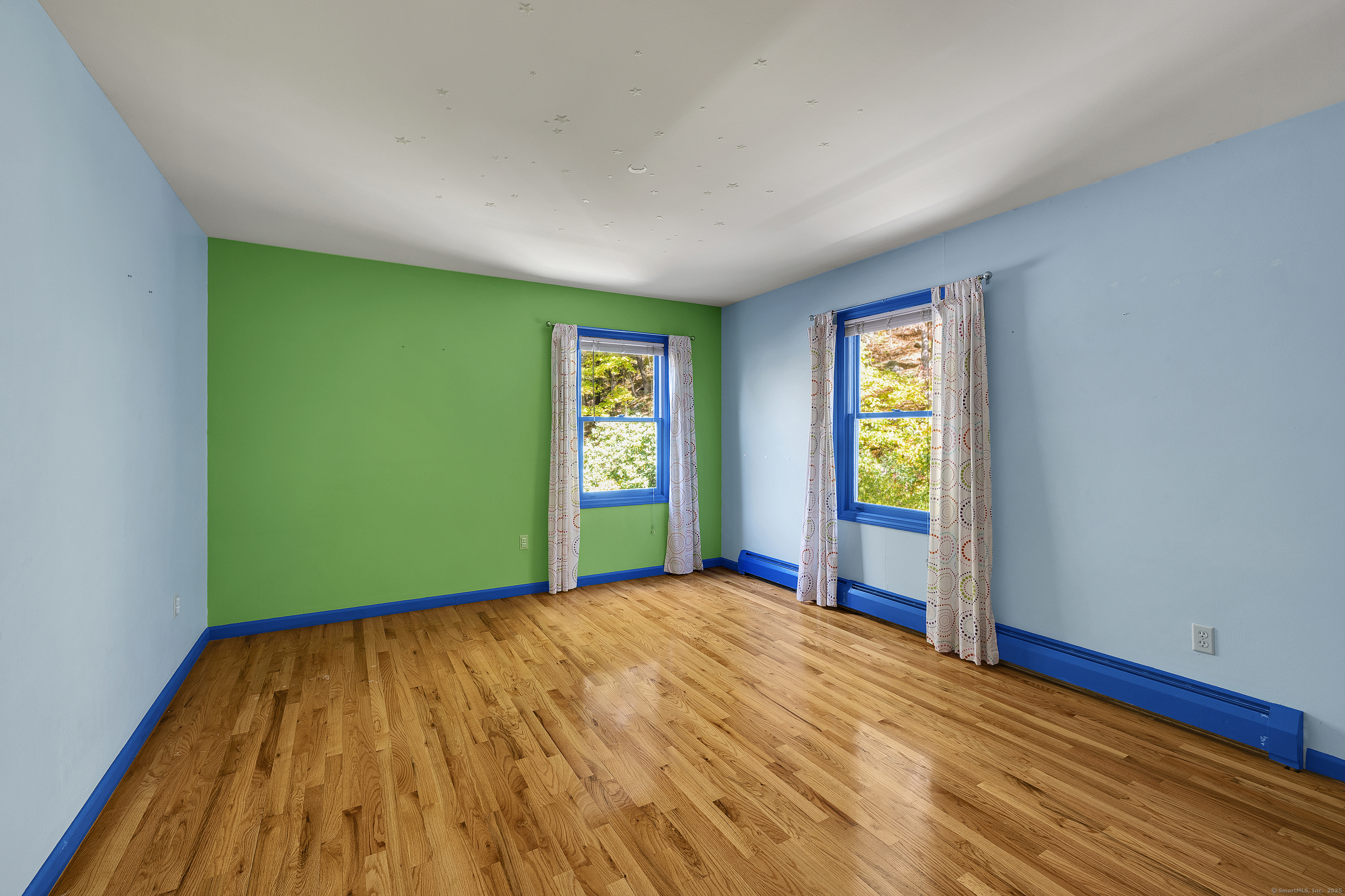 367 Sachem Road Southbury, CT 06488 - Photo 23 of 34 a view of an empty room with window and wooden floor