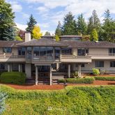 a front view of a residential apartment building with a yard table and chairs
