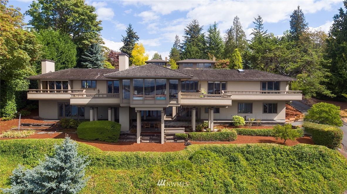 a front view of a residential apartment building with a yard table and chairs
