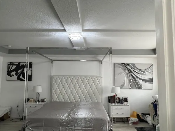 a bedroom with a bed and lamp