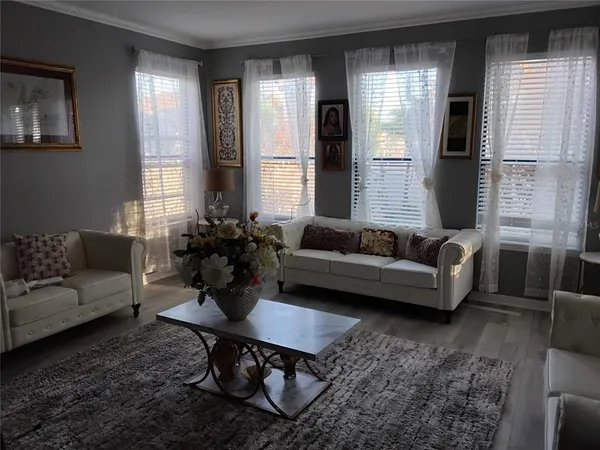 a living room with furniture and wooden floor