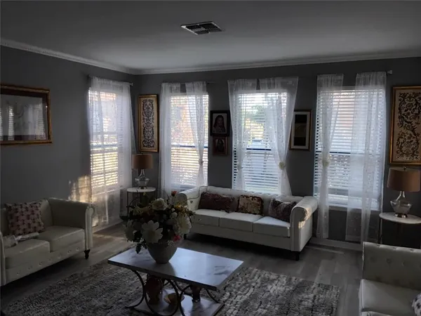 a living room with furniture fireplace and a window