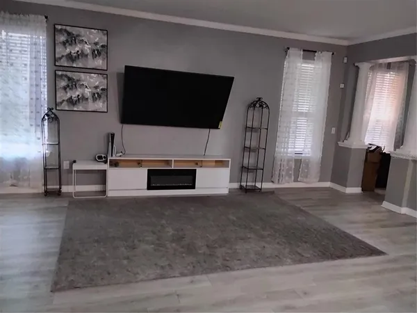 a living room with a flat screen tv and a fireplace