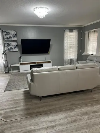 a living room with a flat screen tv and a fireplace