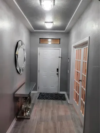 a view of a livingroom with furniture and a mirror