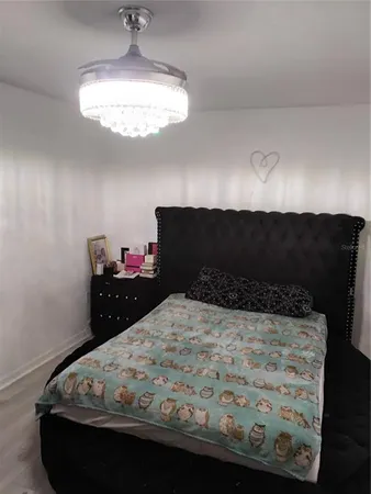 a bed sitting in a bedroom next to a lamp