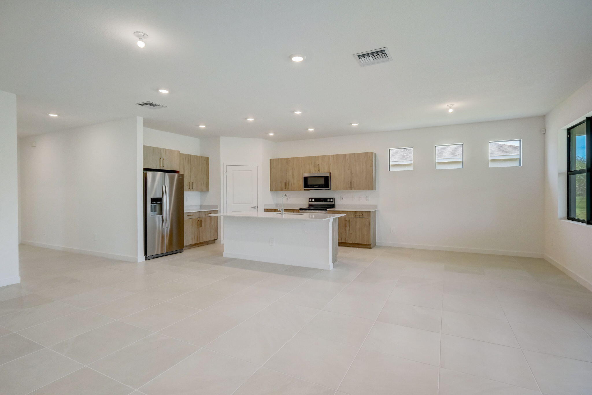 5946 Southeast Sky Blue Circle Stuart, FL 34997 - Photo 7 of 26 living room/kitchen