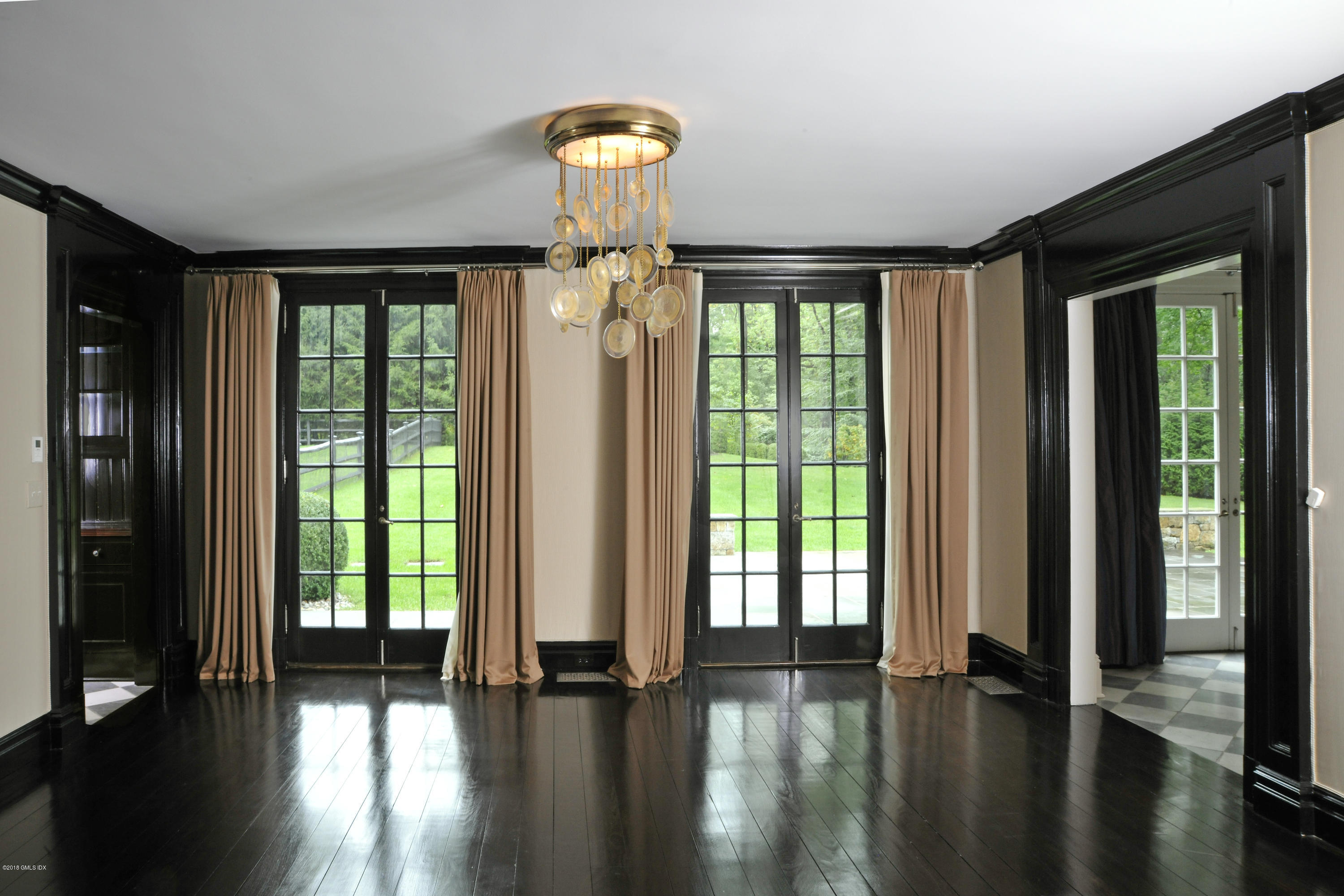 9 Woodside Road Greenwich, CT 06830 - Photo 4 of 20 a view of empty room with wooden floor and fan