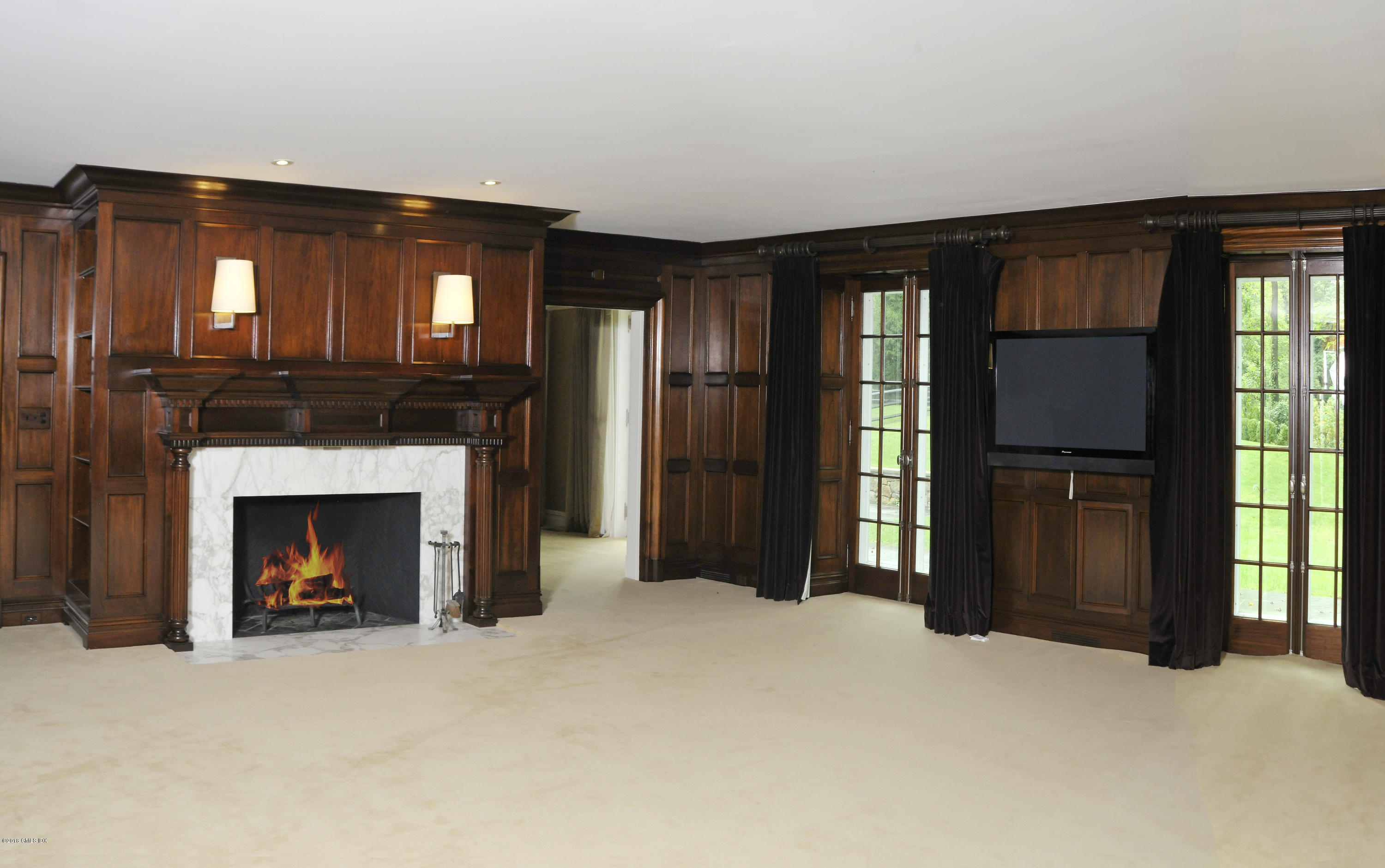 9 Woodside Road Greenwich, CT 06830 - Photo 6 of 20 a view of a livingroom with a fireplace and window