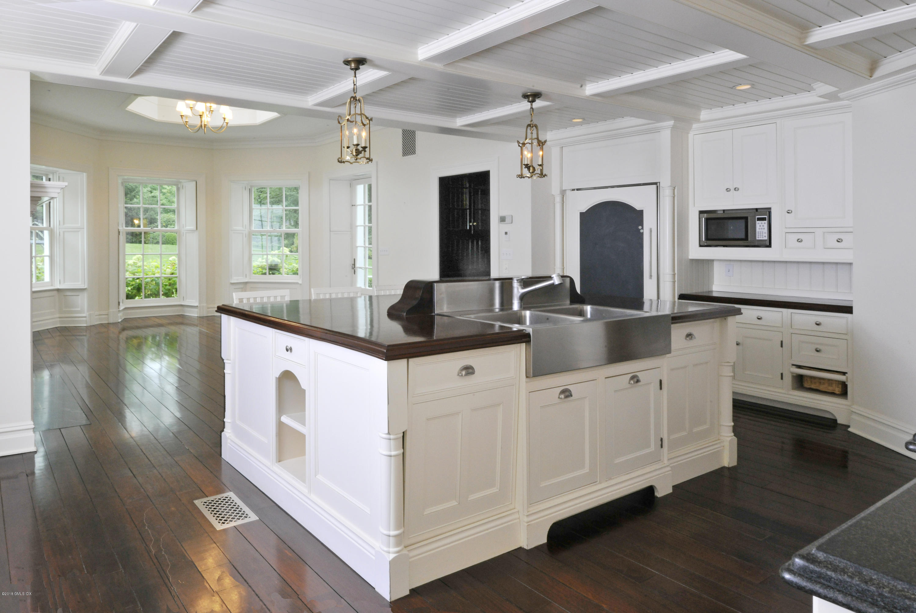 9 Woodside Road Greenwich, CT 06830 - Photo 8 of 20 a kitchen with stainless steel appliances granite countertop a sink and dishwasher with wooden floor
