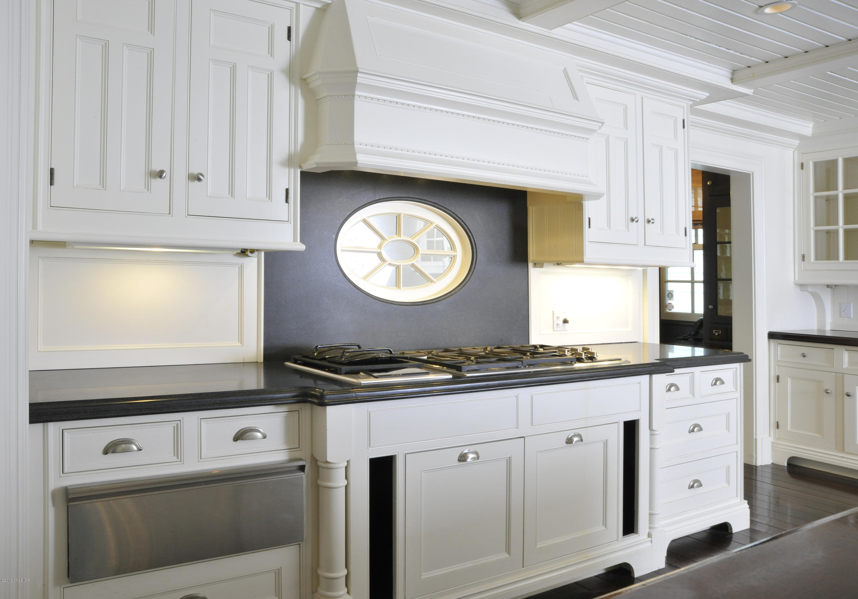 9 Woodside Road Greenwich, CT 06830 - Photo 9 of 20 a kitchen with granite countertop white cabinets and white appliances