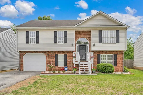 a front view of a house with a yard