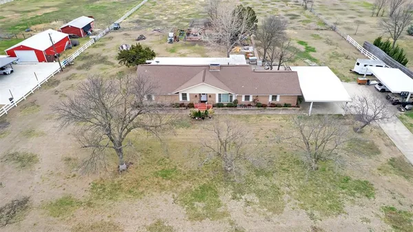 an aerial view of a house with a yard