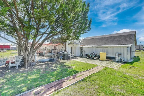 a view of a house with backyard and sitting area