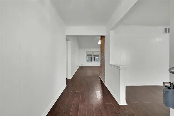 a view of a hallway with wooden floor