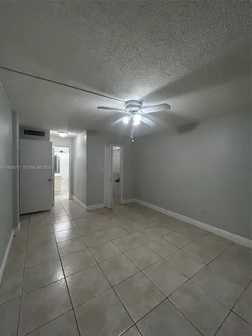 a view of a hallway with chandelier