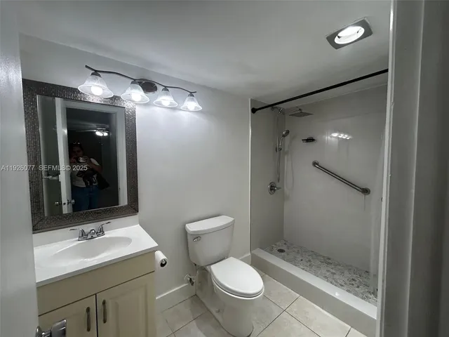 a bathroom with a toilet sink and shower