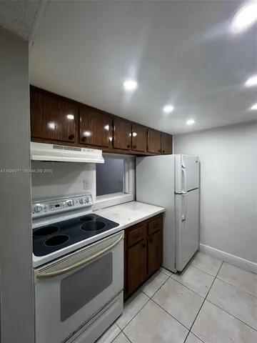 a kitchen that has a sink and a stove in it
