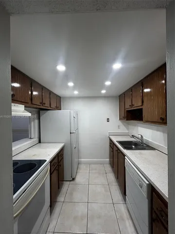 a kitchen with a sink and stainless steel appliances