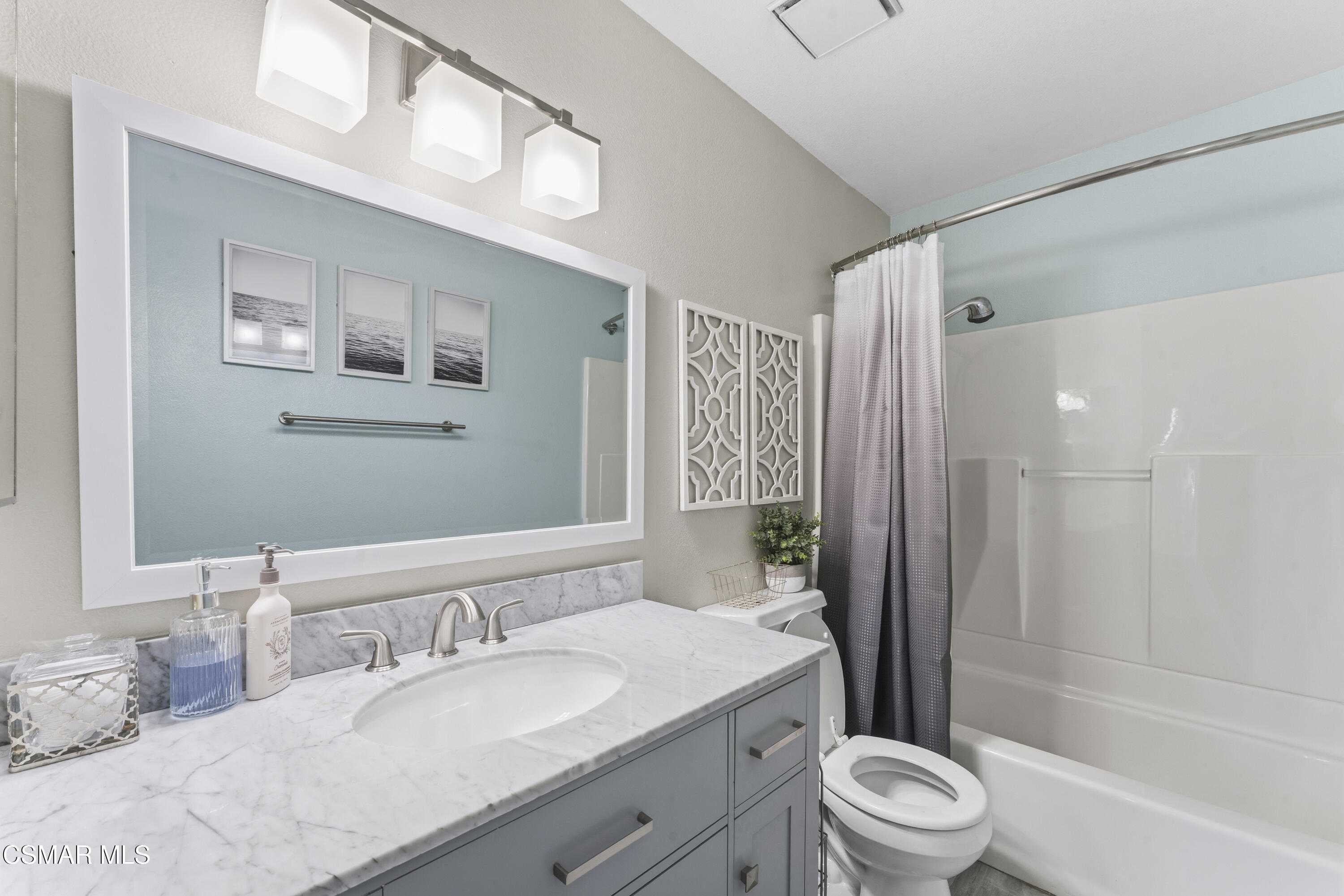 5775 Cochran Street Simi Valley, CA 93063 - Photo 11 of 33 a bathroom with a granite countertop sink toilet a large mirror a bathtub and shower