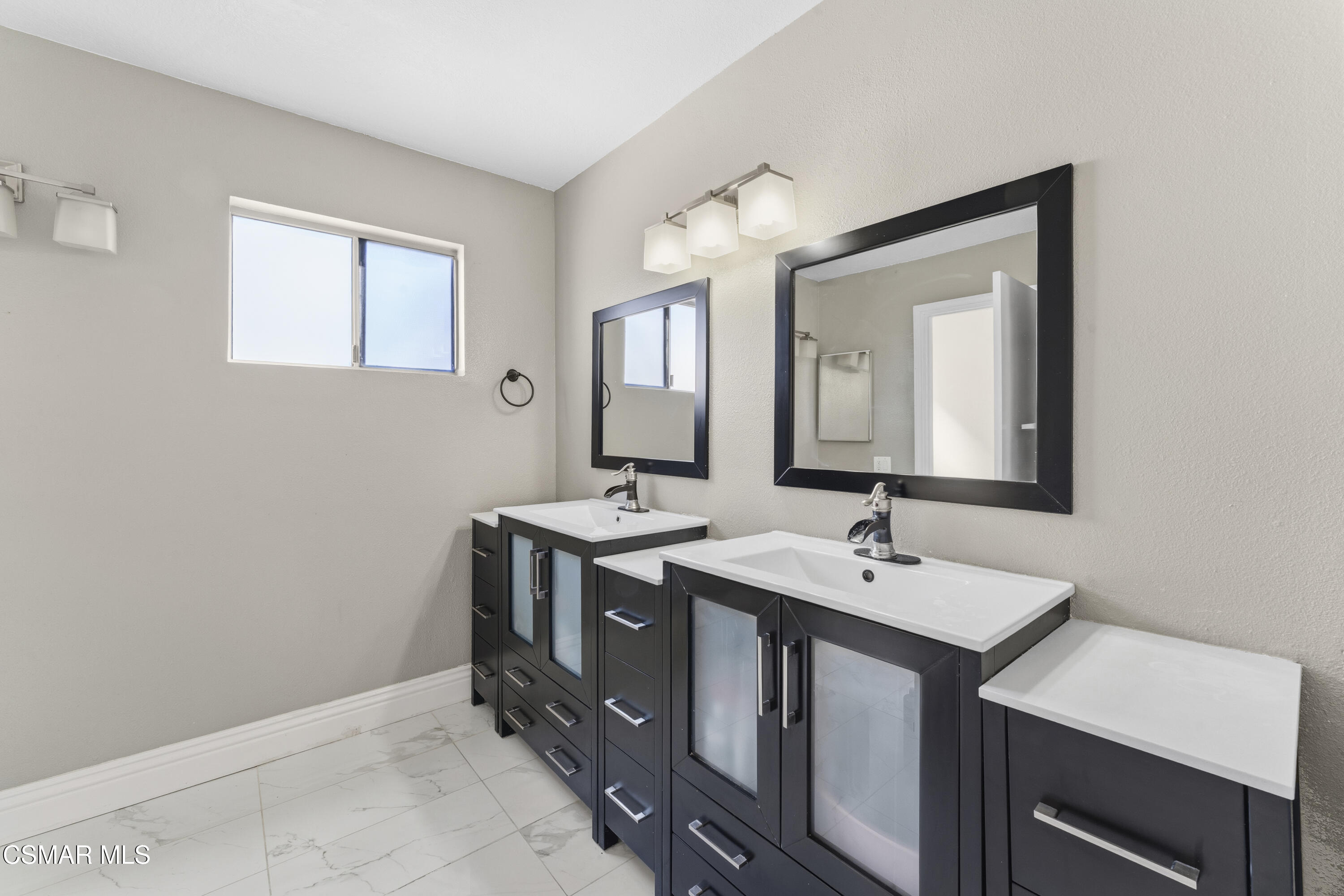 5775 Cochran Street Simi Valley, CA 93063 - Photo 20 of 33 a spacious bathroom with a sink and a mirror