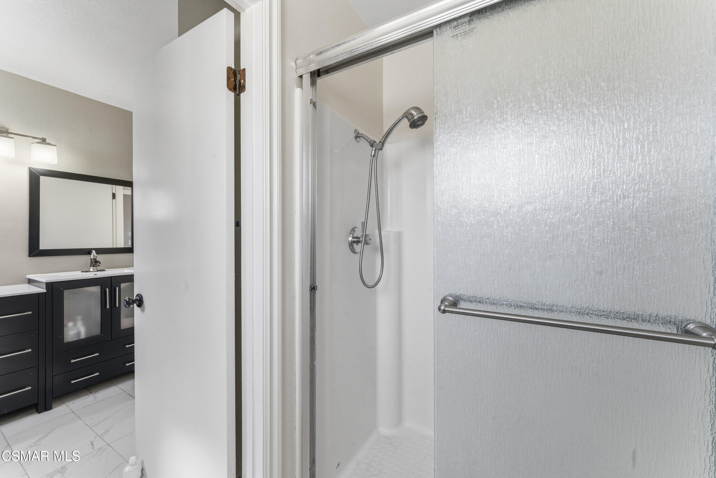 5775 Cochran Street Simi Valley, CA 93063 - Photo 22 of 33 a bathroom with a shower and a sink