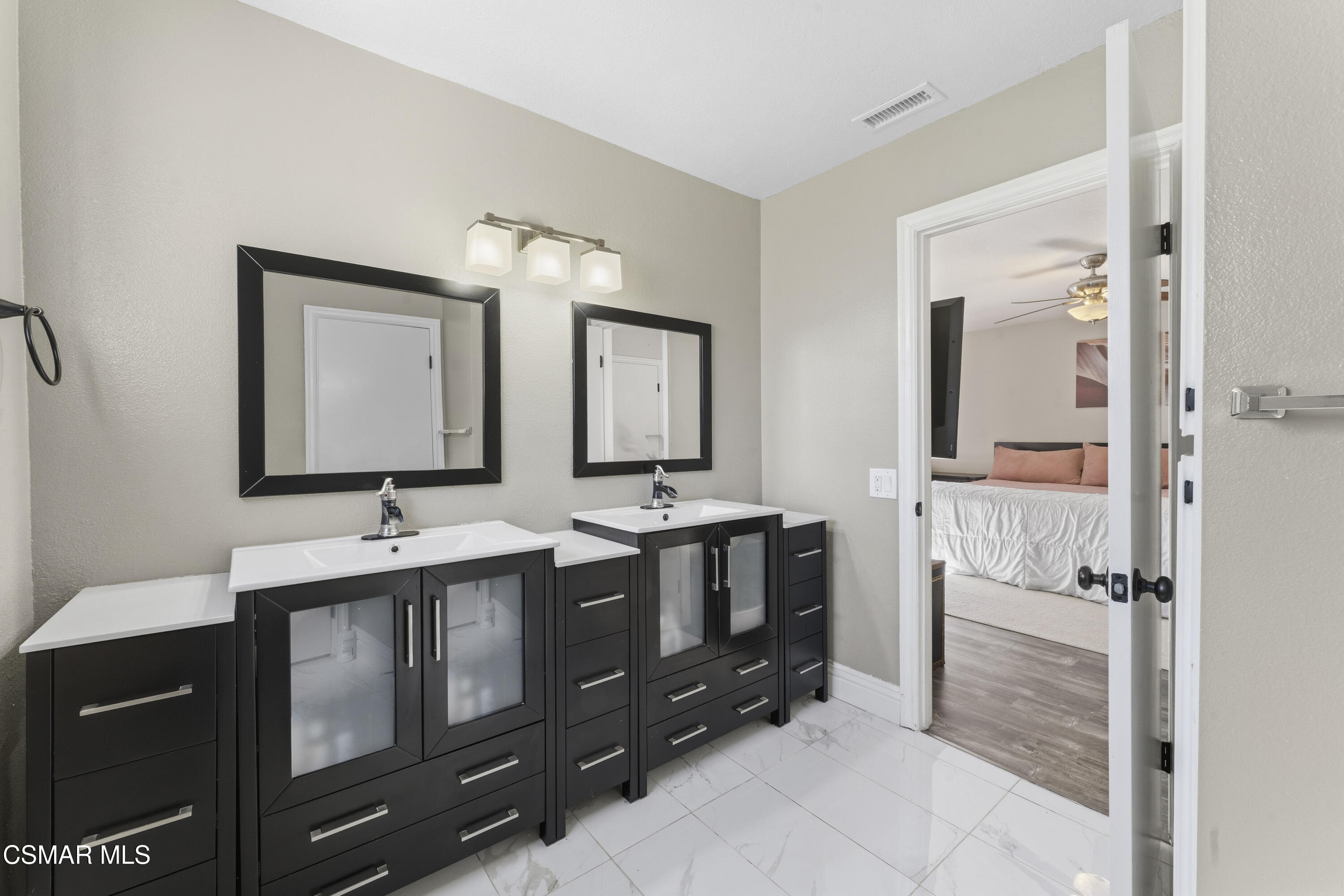 5775 Cochran Street Simi Valley, CA 93063 - Photo 23 of 33 a bathroom with double vanity and two mirrors
