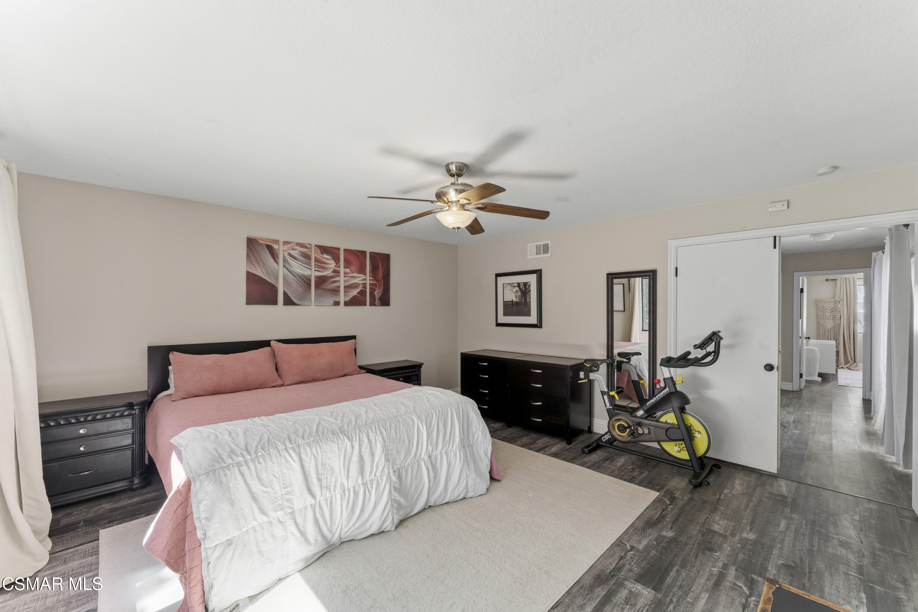 5775 Cochran Street Simi Valley, CA 93063 - Photo 26 of 33 a bedroom with a bed and wooden floor