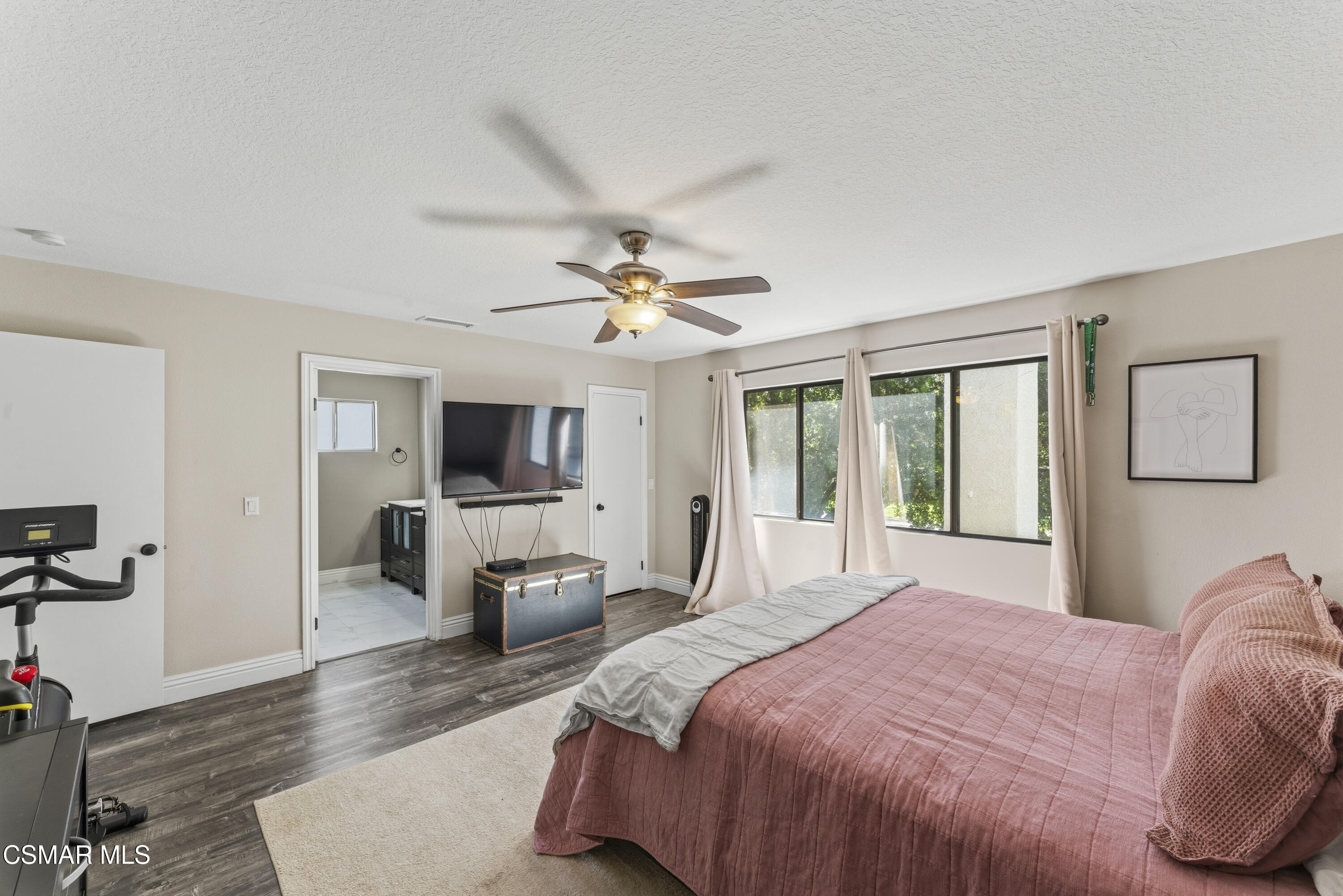 5775 Cochran Street Simi Valley, CA 93063 - Photo 27 of 33 a bedroom with a large bed and a flat screen tv