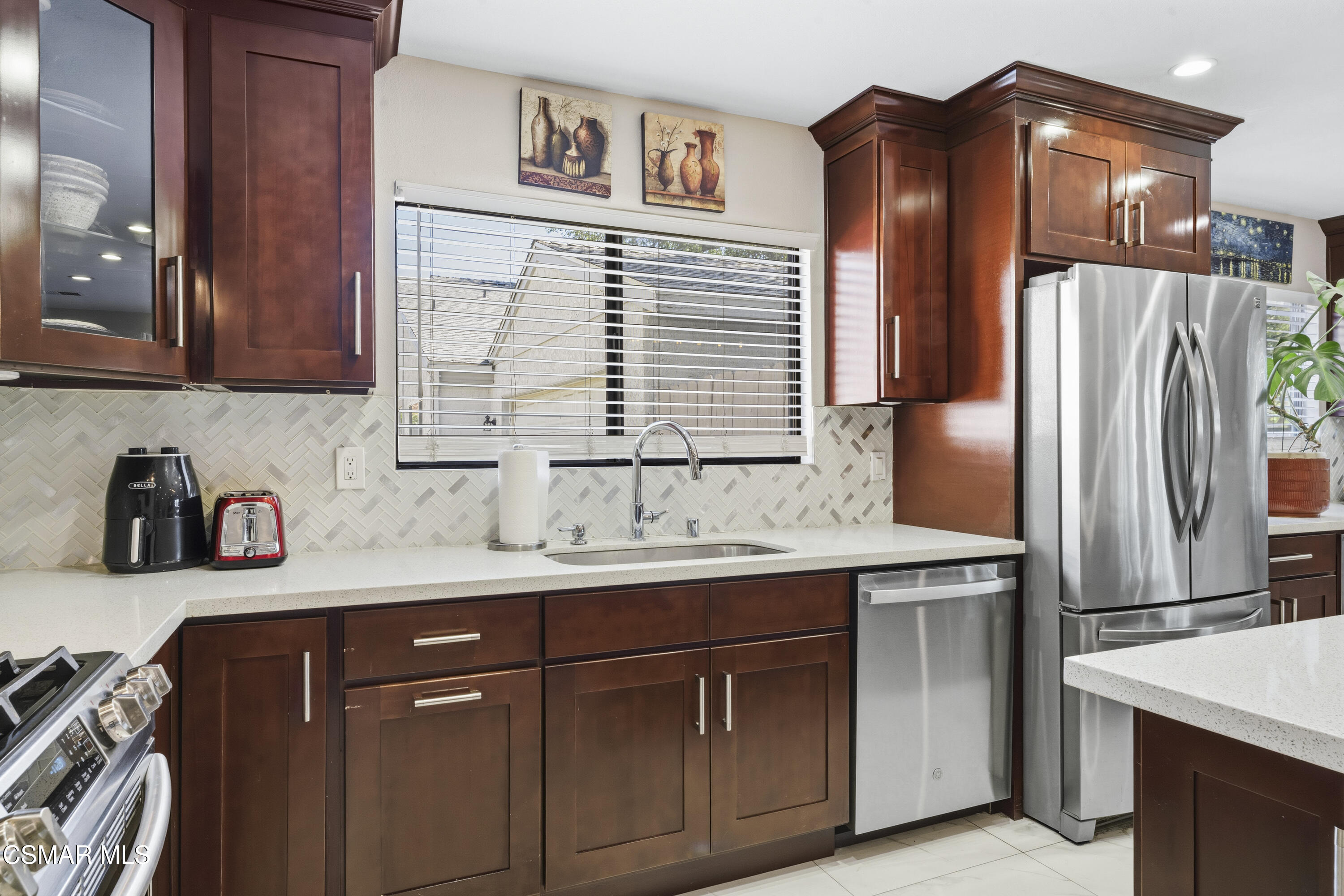 5775 Cochran Street Simi Valley, CA 93063 - Photo 4 of 33 a kitchen with stainless steel appliances granite countertop a sink and a refrigerator