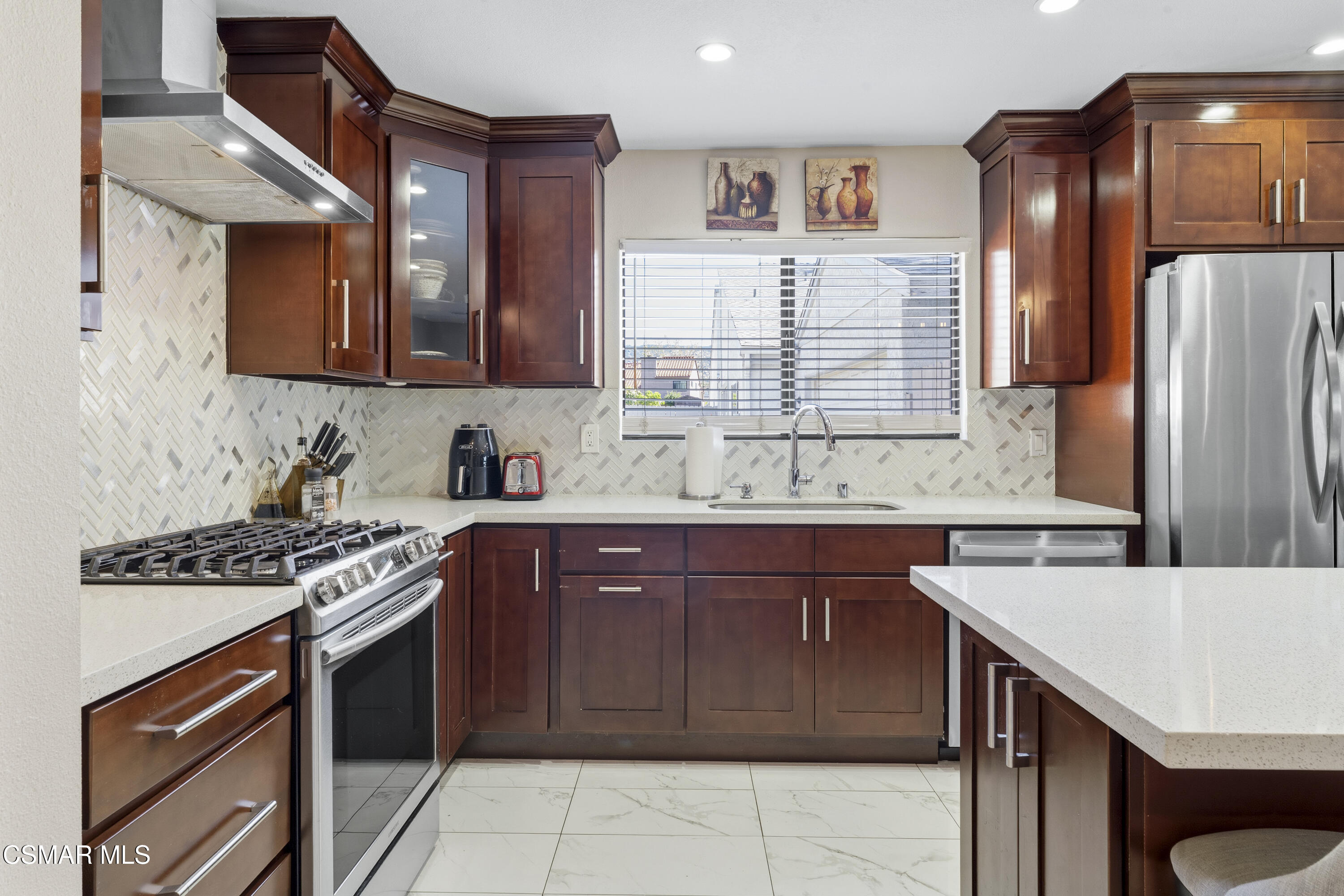 5775 Cochran Street Simi Valley, CA 93063 - Photo 5 of 33 a kitchen with a stove a sink and a refrigerator