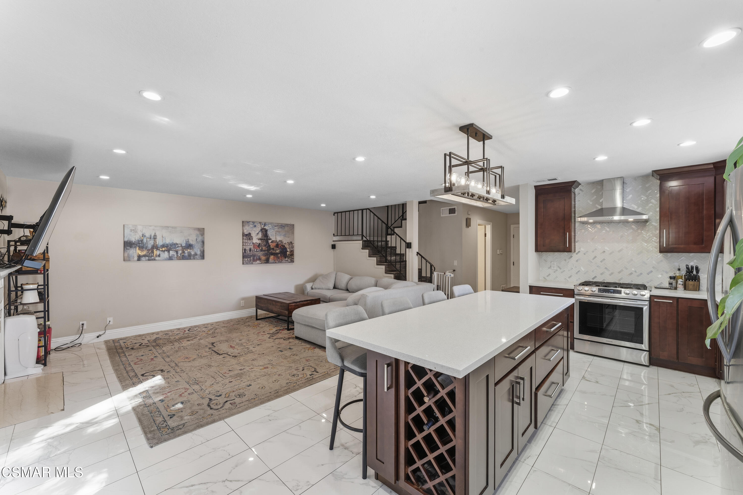 5775 Cochran Street Simi Valley, CA 93063 - Photo 6 of 33 a living room with stainless steel appliances furniture a rug and a kitchen view