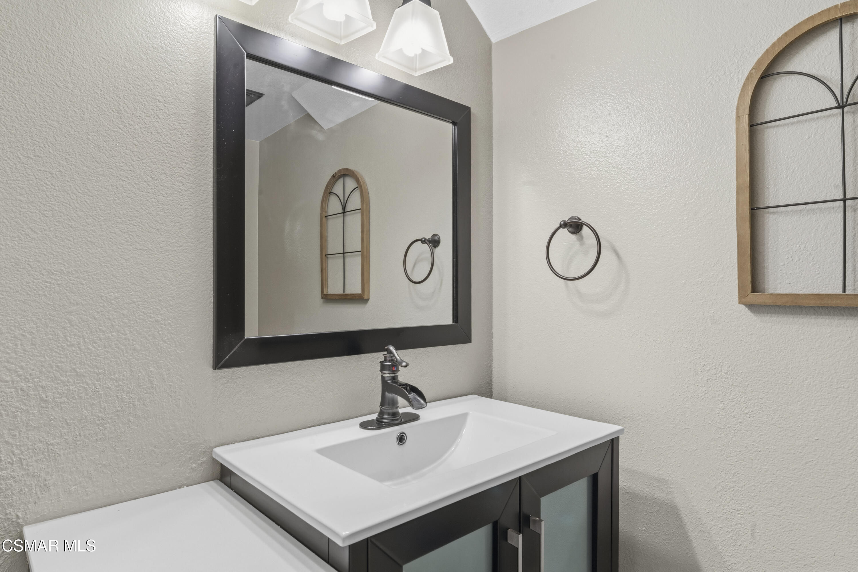 5775 Cochran Street Simi Valley, CA 93063 - Photo 10 of 33 a bathroom with a sink and a mirror