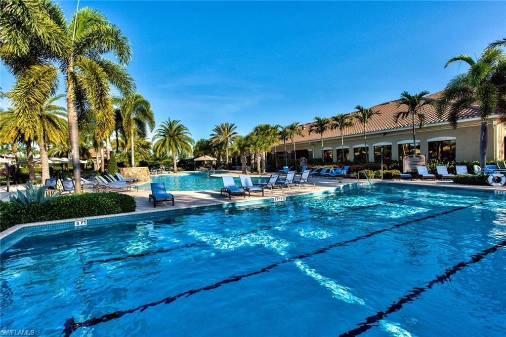 3424 Atlantic Circle Naples, FL 34119 - Photo 12 of 14 a view of swimming pool with lawn chairs and tables