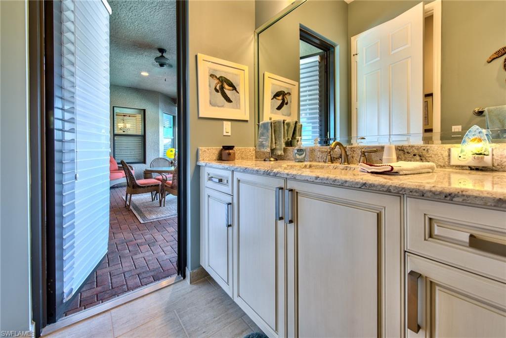 3424 Atlantic Circle Naples, FL 34119 - Photo 7 of 14 a en suite bathroom with sink and mirror