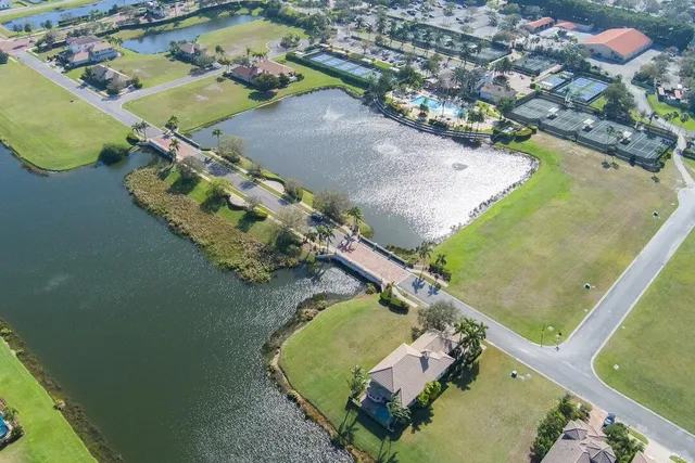 an aerial view of a house a yard and a ocean