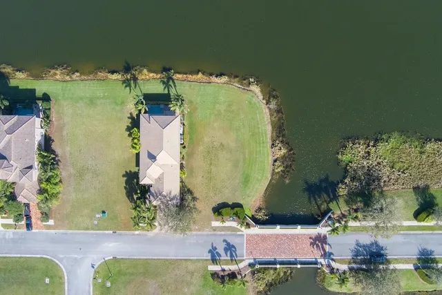 an aerial view of a house with yard swimming pool and outdoor seating