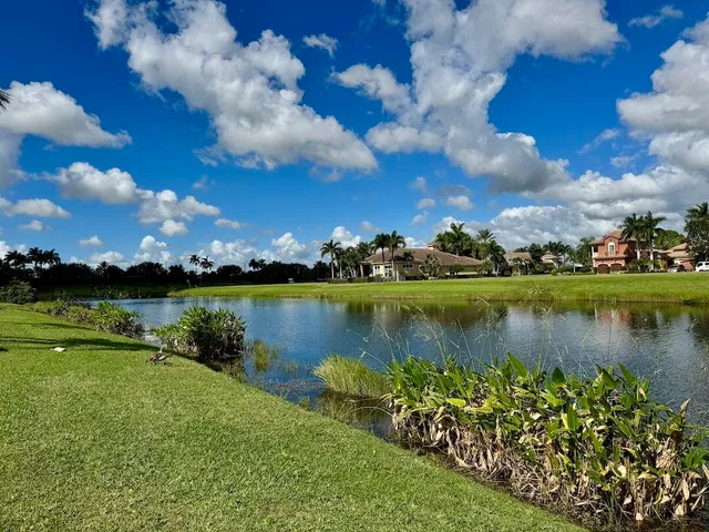 an aerial view of a house with a garden and lake view