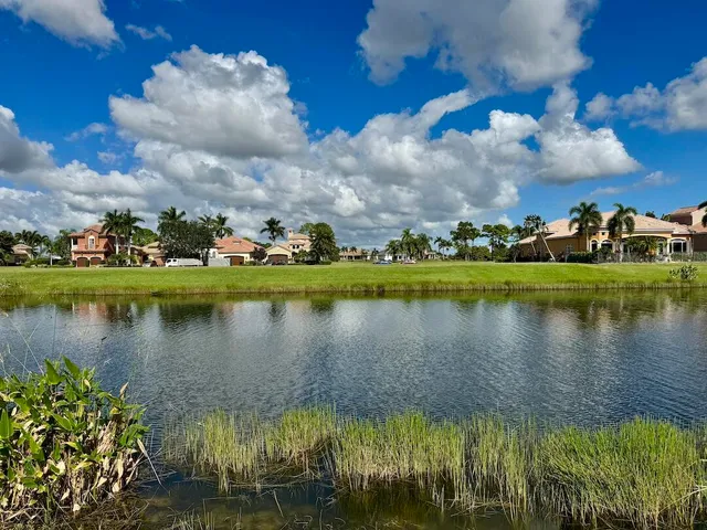 a view of a lake with houses in the background
