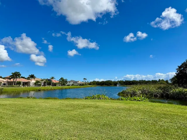 a view of a lake with houses in the background