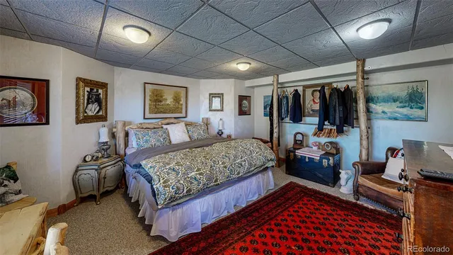 a bedroom with a bed couch and window