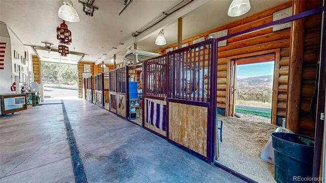 a view of a hallway with wooden floor and stairs