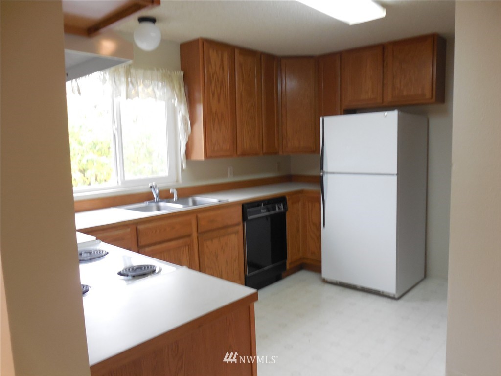 707 Sheridan Road, Unit A&B Bremerton, WA 98310 - Photo 5 of 12 a kitchen with a sink a stove and a refrigerator