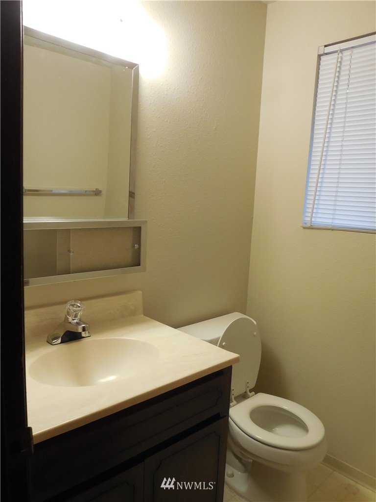 707 Sheridan Road, Unit A&B Bremerton, WA 98310 - Photo 6 of 12 a bathroom with a sink a toilet and mirror