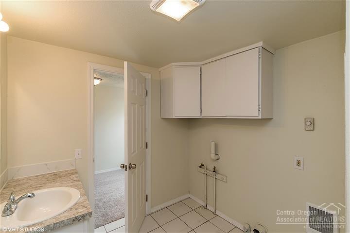756 Southwest 3rd Street Madras, OR 97741 - Photo 17 of 24 Laundry area in bathroom with linen cabi