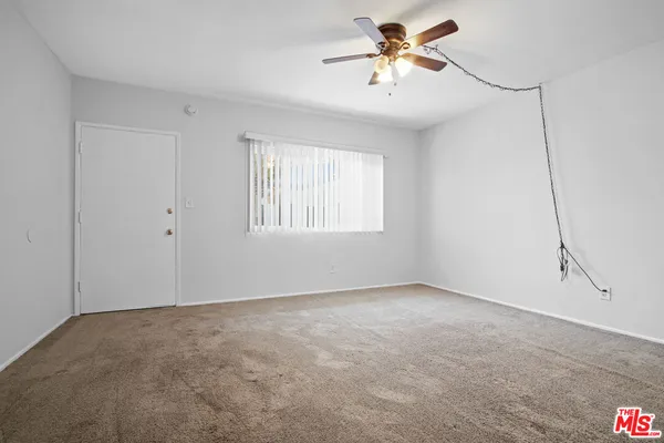 a kitchen with cabinets appliances a sink and a window