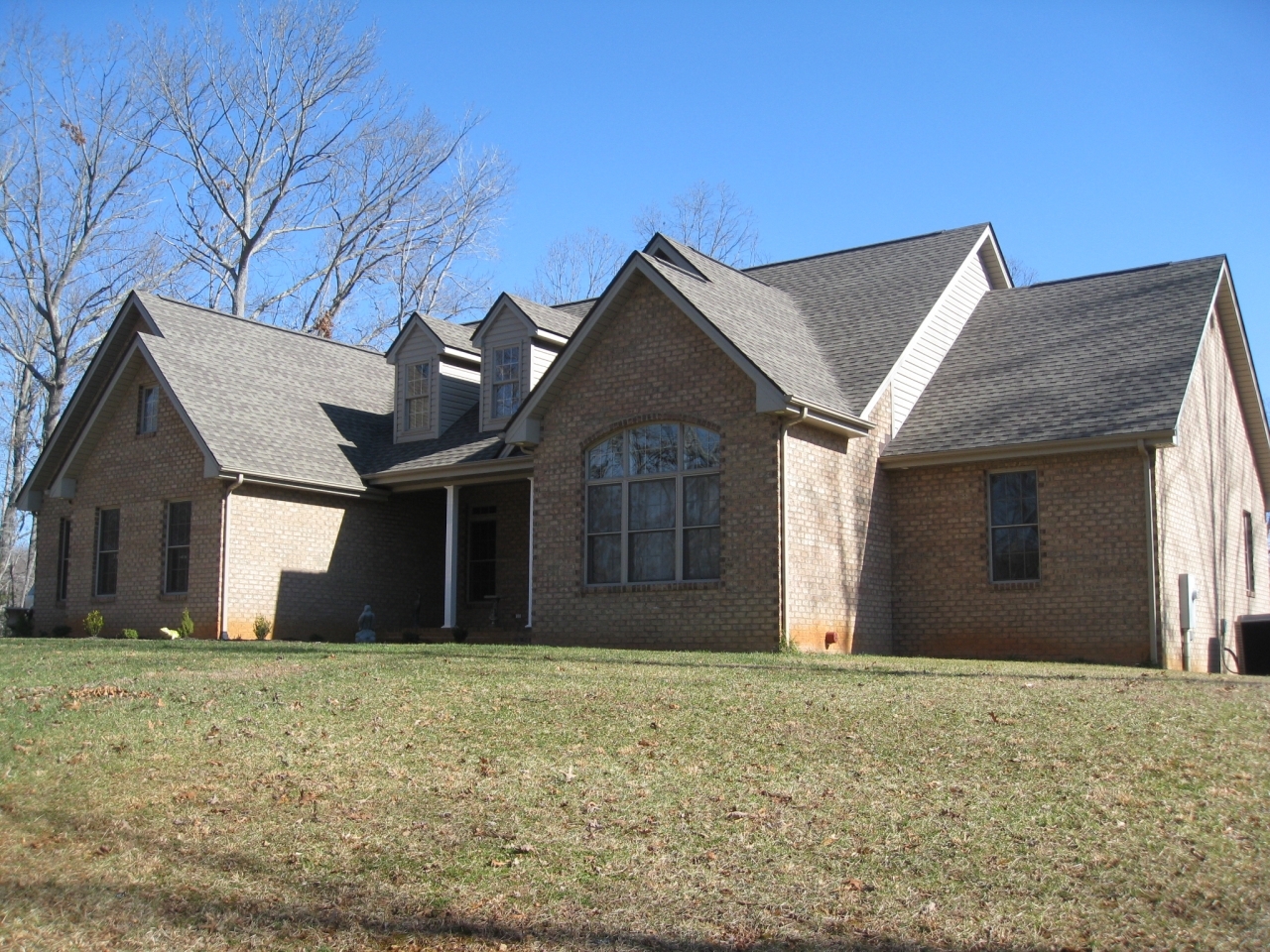 1088 Loggers Road Goodview, VA 24095 - Photo 3 of 22 a front view of a house with a yard and garage